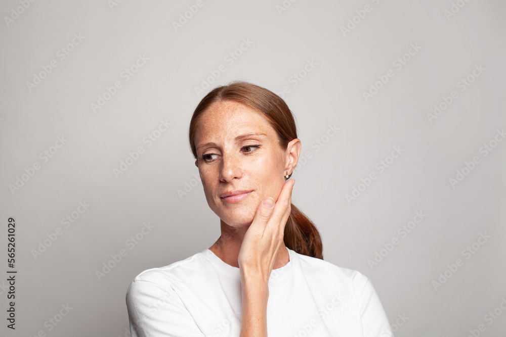 Beautiful mid adult woman with healthy clear skin. Female face closeup. Skin care, facial treatment and medicine concept Beautiful mid adult woman with healthy clear skin. Female face closeup. Skin care, facial treatment and medicine concept