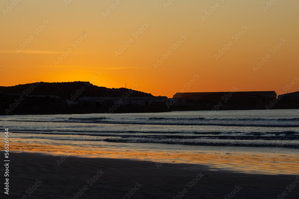 On the beach of Paternoster during sunset, orange sky, water, evening, Western Cape, South Africa