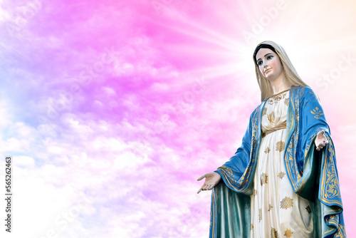 Statue of Our lady of grace virgin Mary with beautiful Sky Pastel with abstract colored background and wallpaper in sweet color. at Thailand.