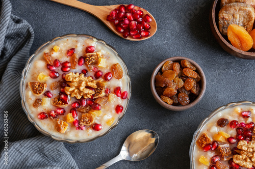 Traditional Turkish delicious mixed dessert, ashura (asure) with pomegranate seeds, walnut, apricot, Noah’s pudding photo