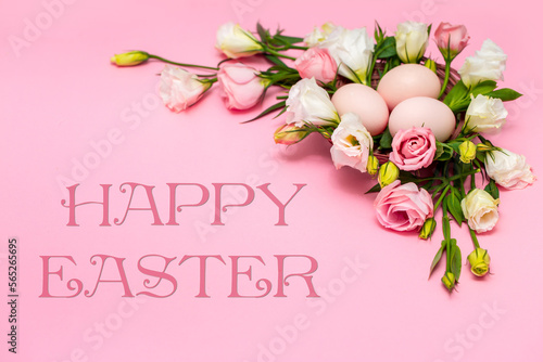 Easter background with Easter eggs and spring flowers. Top view with copy space. Nest with eggs decorated with beautiful flowers on a pink background.