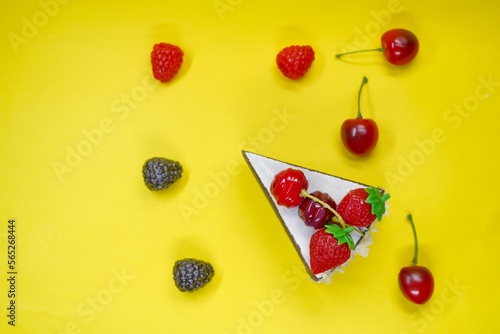 chocolate cake with strawberry and berry on yellow background