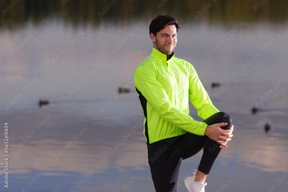Fototapeta premium Man Stretching Legs During Running Exercises Outdoor