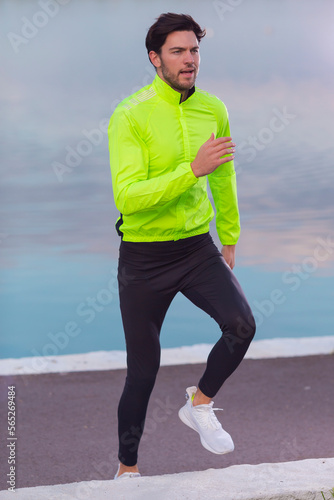 Runner Man During Road Training for High Intensity Interval Training and Sprint Workout Outdoors At Fall Near Scenic River Bank As Male Athlete Model