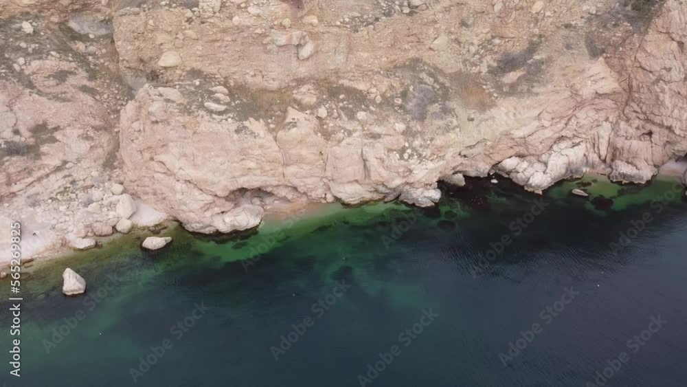 Beautiful remote beach with crystal clear water, aerial view. Untouched nature and hidden sandy beach with seagulls. Motion blur on small waves. Holiday, vacation and travel concept. Nobody Beautiful remote beach with crystal clear water, aerial view. Untouched nature and hidden sandy beach with seagulls. Motion blur on small waves. Holiday, vacation and travel concept. Nobody