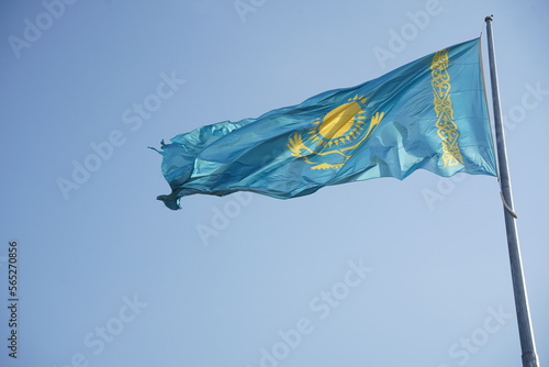 Almaty, Kazakhstan - 09.16.2022 : The national flag of the Republic of Kazakhstan on a large flagpole in the city center.