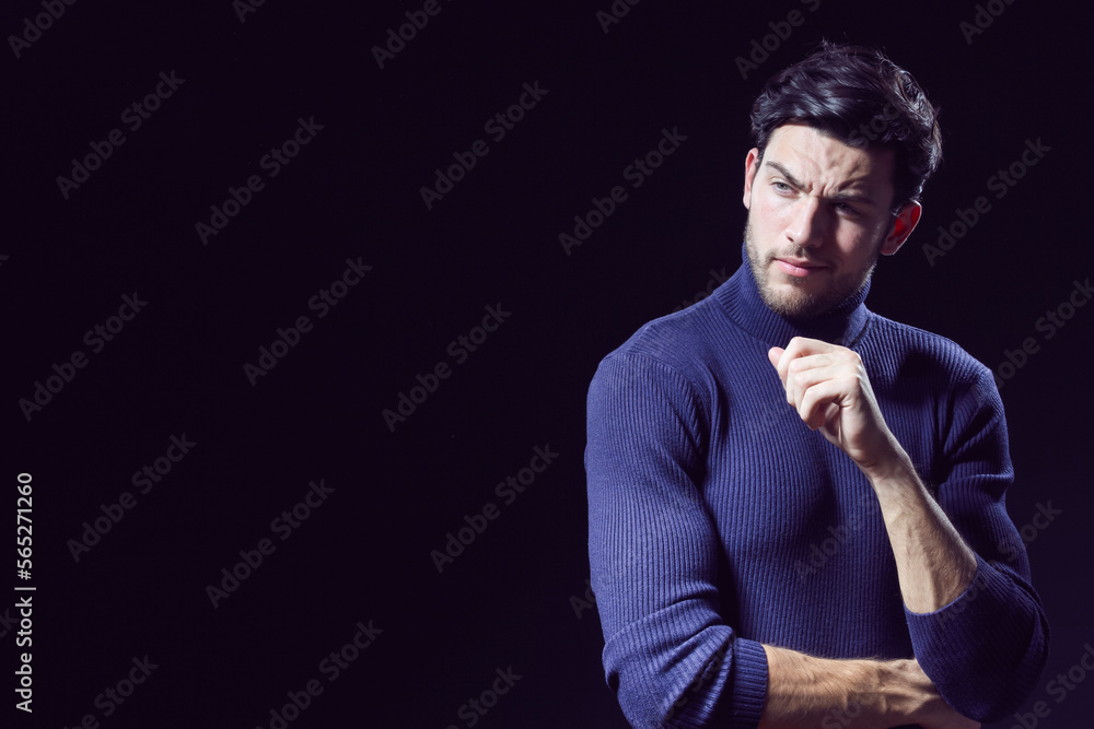 One Calm Caucasian Handsome Brunet Man Posing in Blue Turtle Neck Sweater With Folded Hands Against Grey Background as Successful Young Man.