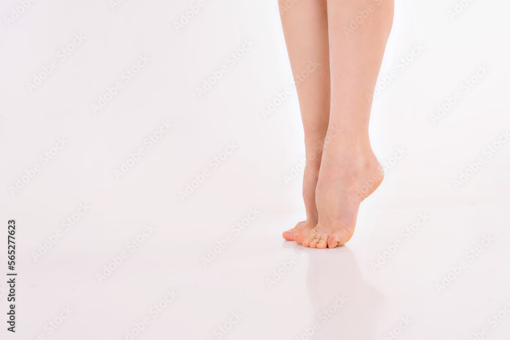 beautiful women's feet on white background. Pure white skin of the feet, shaving the legs with a razor, varicose veins, corns, warts, leg cream beautiful women's feet on white background. Pure white skin of the feet, shaving the legs with a razor, varicose veins, corns, warts, leg cream