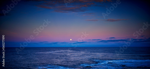 full moon above the ocean