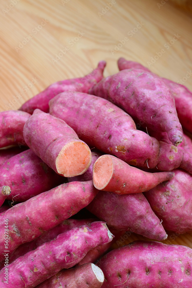 Pile of Raw Sweet Potatoes on the Wooden Table Pile of Raw Sweet Potatoes on the Wooden Table