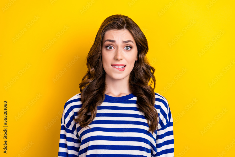 Photo of young nervous woman bite lip oops forgot turn off electronics home stress stunned problems dissatisfied isolated on yellow color background Photo of young nervous woman bite lip oops forgot turn off electronics home stress stunned problems dissatisfied isolated on yellow color background