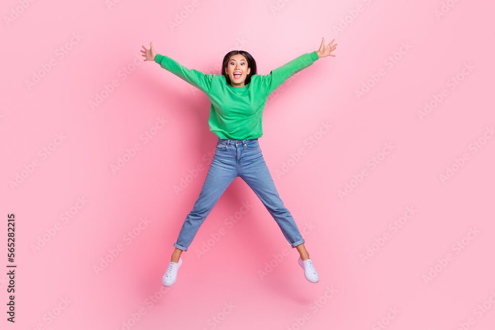 Full size photo of overjoyed cheerful thai girl jumping make star figure isolated on pink color background