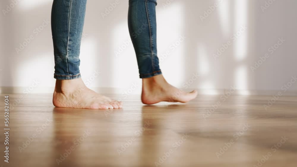 Beautiful Female Bare Feet Walk along the Parquet Floor of the House in Sunshine. Slow Motion. Beautiful Female Bare Feet Walk along the Parquet Floor of the House in Sunshine. Slow Motion.