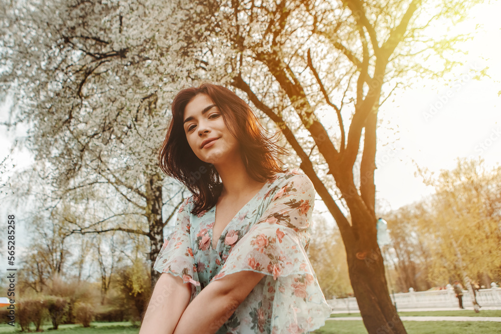 Portrait of charming pretty woman dressed flowery dress sitting on bench near apple cherry tree blossoms blooming flowers in the garden park in early spring nature. Fashion, holiday
Portrait of charming pretty woman dressed flowery dress sitting on bench near apple cherry tree blossoms blooming flowers in the garden park in early spring nature. Fashion, holiday