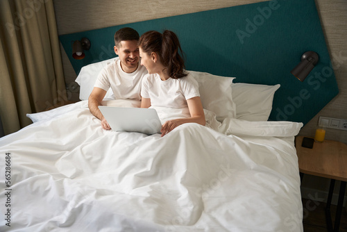 Handsome man and his girlfriend spend time in bed