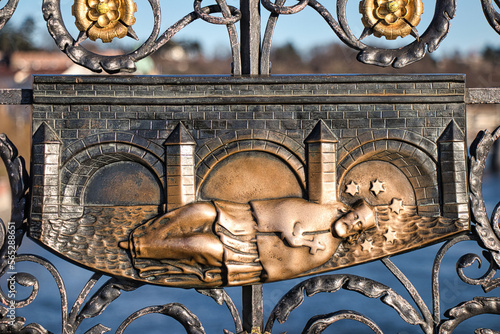 A detail view of iron forged grid with Saint John of Nepomuk relief on Charles Bridge in Prague, Czech Republic.