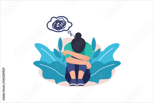 Woman in depression with bewildered thoughts in her mind. Young sad girl sitting and unhappy hugging her knees.