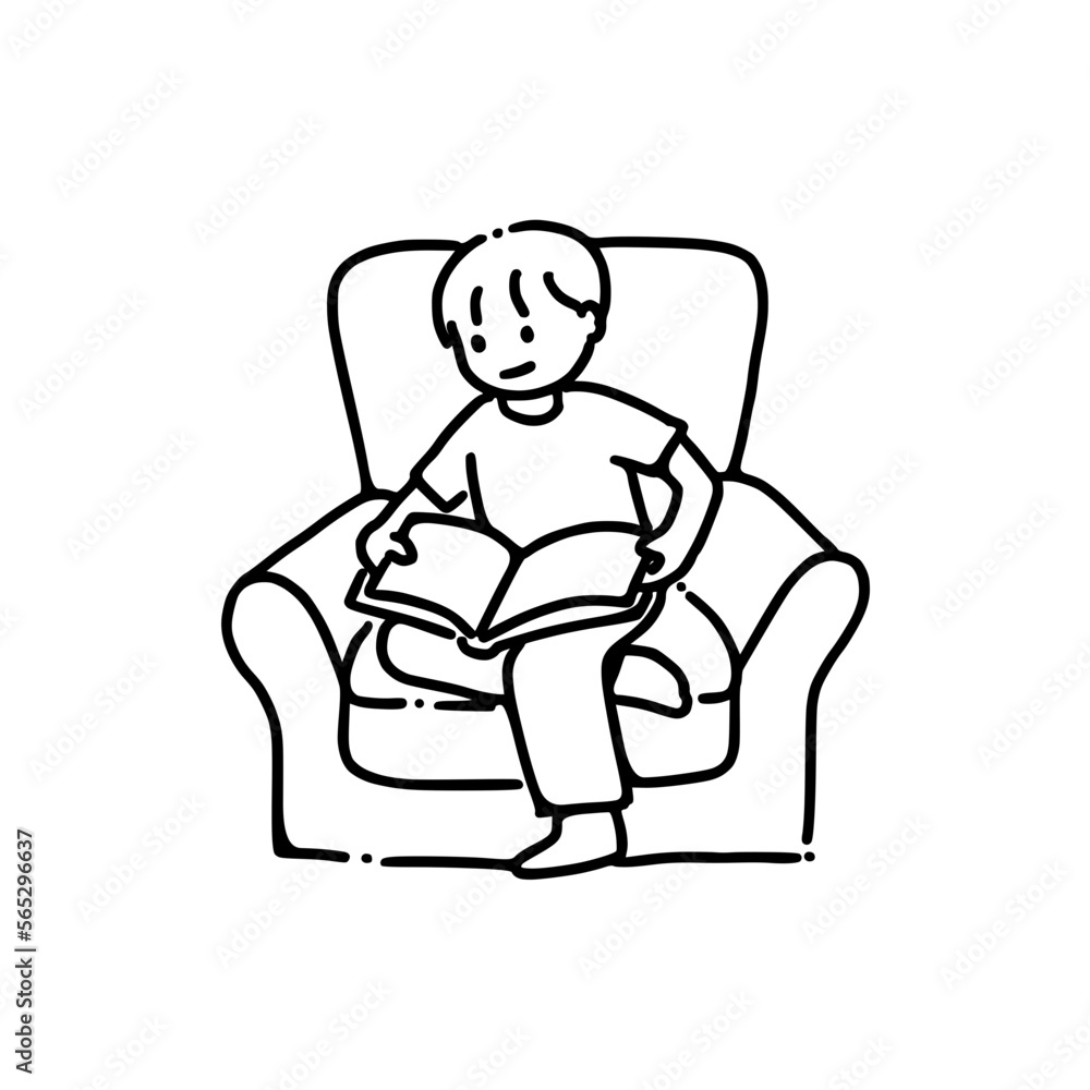 An adolescent boy reading a book on an armchair An adolescent boy reading a book on an armchair