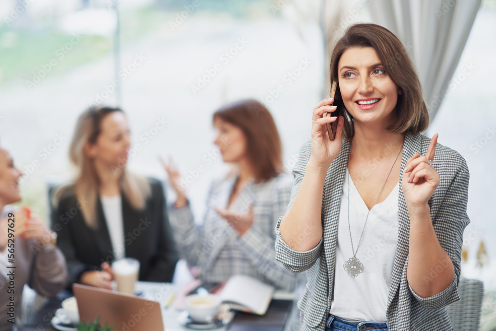 Picture of business woman with cell phone on meeting
