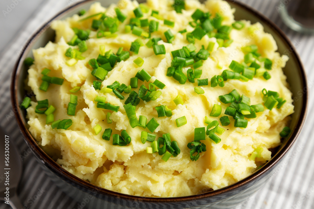 Homemade Mashed Potatoes with Chives in a Bowl, side view. Close-up. Homemade Mashed Potatoes with Chives in a Bowl, side view. Close-up.