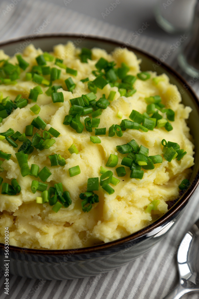 Homemade Mashed Potatoes with Chives in a Bowl, side view. Close-up. Homemade Mashed Potatoes with Chives in a Bowl, side view. Close-up.