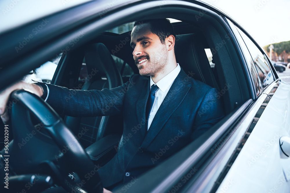 young driver handsome businessman wear suit driving car-Side profile view of smiling manager outdoors sitting on taxi-Success in motion-Happy man looking a street-Lifestyle Status and business concept