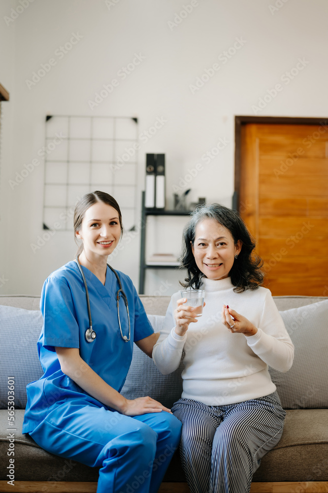 Asian female hands touching old female hand Helping hands holding bottle with pills in hands, reading instruction take care of the elderly concept. Asian female hands touching old female hand Helping hands holding bottle with pills in hands, reading instruction take care of the elderly concept.