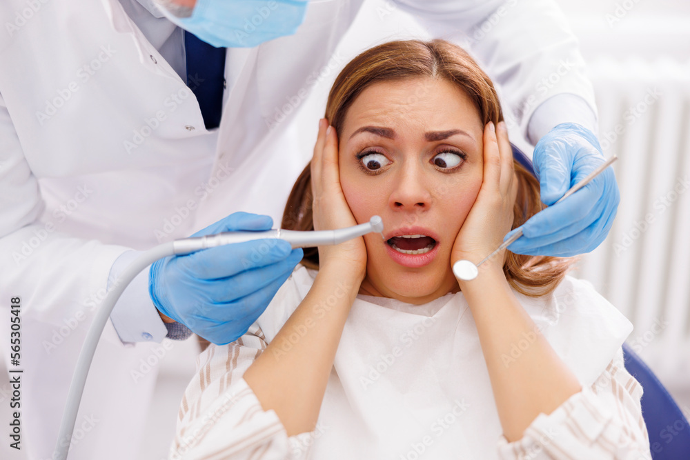 Woman afraid at dentist office Woman afraid at dentist office
