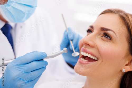 Dentist fixing patient s tooth