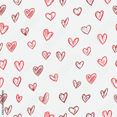 Seamless vector pattern on a light pink background scarlet hearts. For a declaration of love or Valentine's Day. 