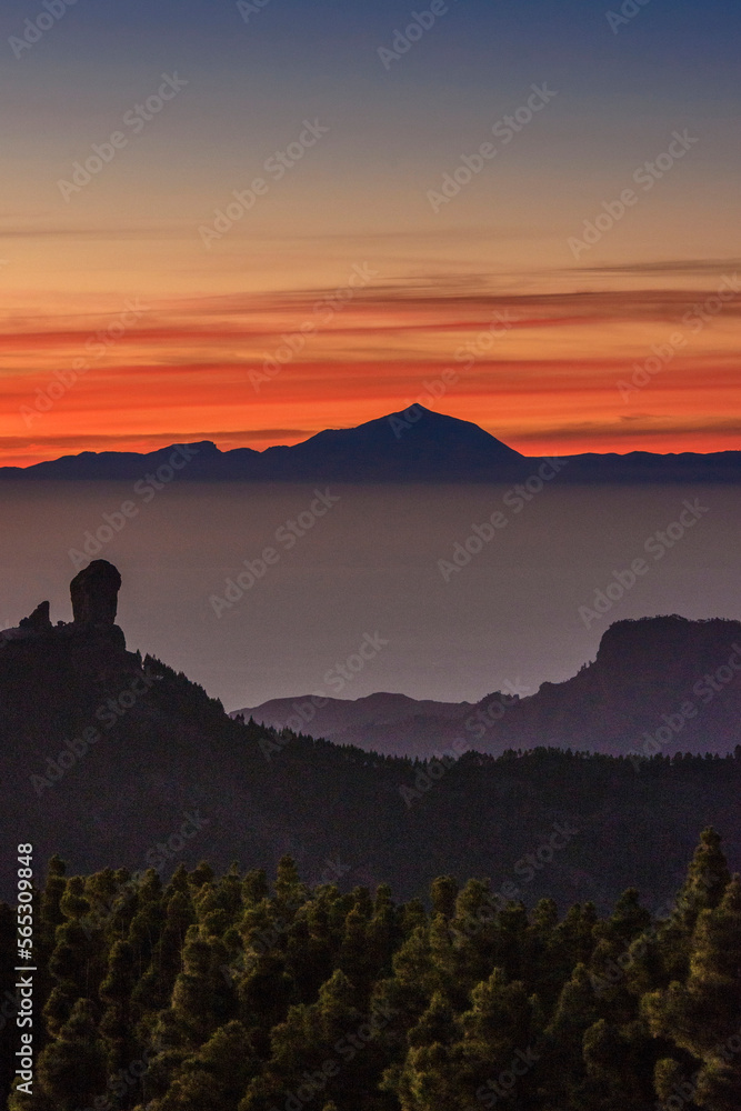 View of Roque Nublo and the magestic Teide peak on the island of Tenerife in the background at sunset, Roque Nublo Rural Park, Gran Canary, Canary Islands, Spain
