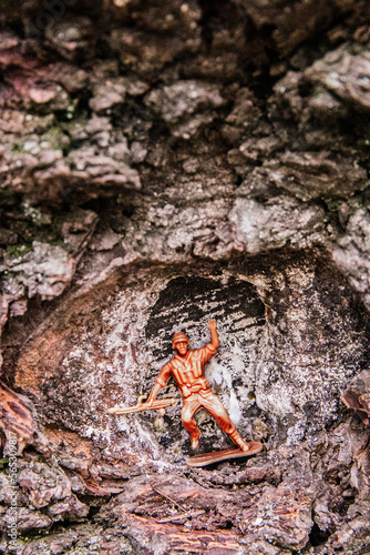 Plastic toy soldier in tree hole photo