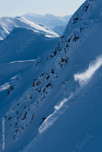 Skier quickly going down a mountain. photo