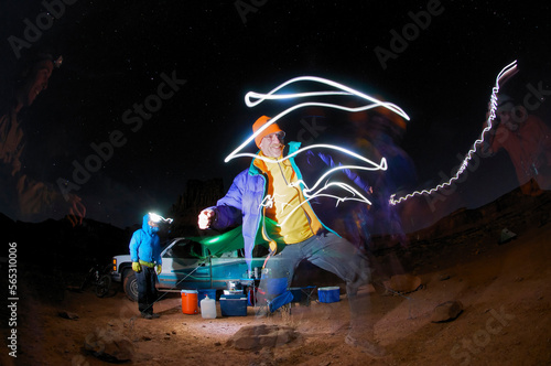 Four men at a camp site at night. photo