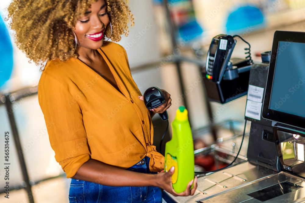 African American Woman buying food at grocery store or supermarket self-checkout African American Woman buying food at grocery store or supermarket self-checkout