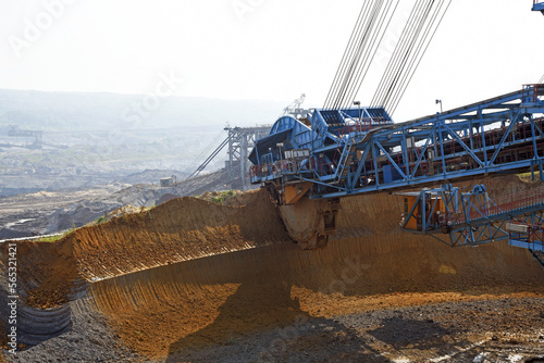 Bucket-wheel excavator during excavation at the surface mine. Huge excavator on open pit mine.