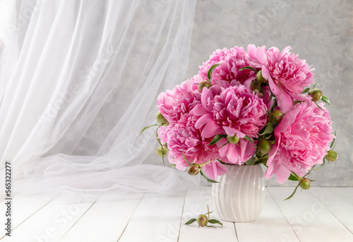 Bouquet of pink peonies in a vase on a wooden table. Gift Valentine s Day