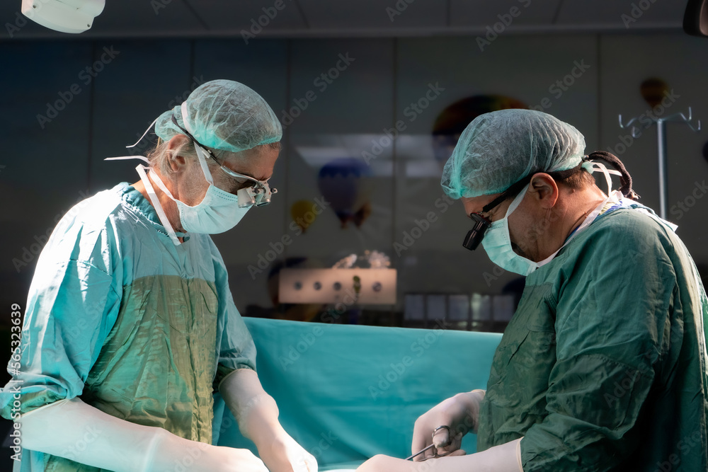 Open heart surgery, doctors and cardiologists perform open heart surgery. Doctors in green uniforms in the operating room. Open heart surgery, doctors and cardiologists perform open heart surgery. Doctors in green uniforms in the operating room.