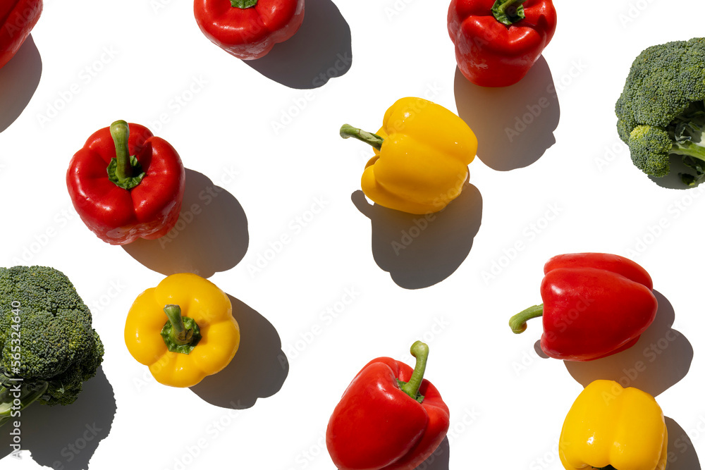 Fresh paprika and broccoli on a white background. Top view, flat lay
