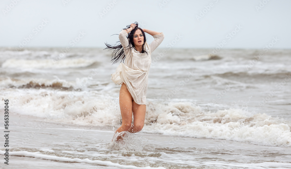 Seminude woman in the cold sea waves Seminude woman in the cold sea waves
