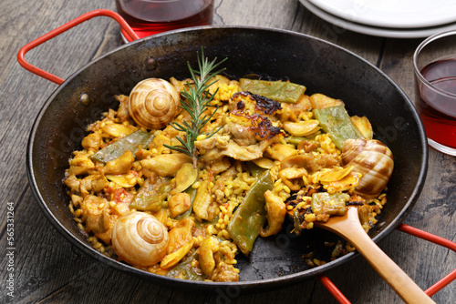 traditional Valencian paella in Spain; rabbit, chicken, garrofon beans, snails, Moroccan green beans, saffron, and bomba rice.