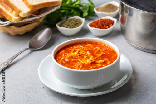 Chicken noodle soup with tomato. Turkish name; Domatesli tavuklu sehriye corbasi photo