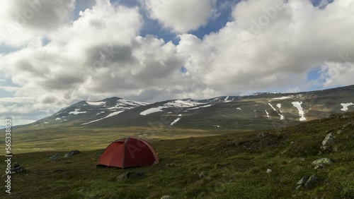 orange tent in the mountains photo