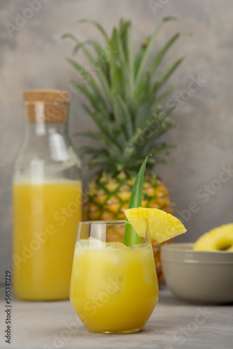 Pineapple cocktail in glass jars on wooden table closeup