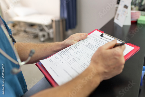 Close up shot of a medical form filled up by a health care personnel in the clinic photo