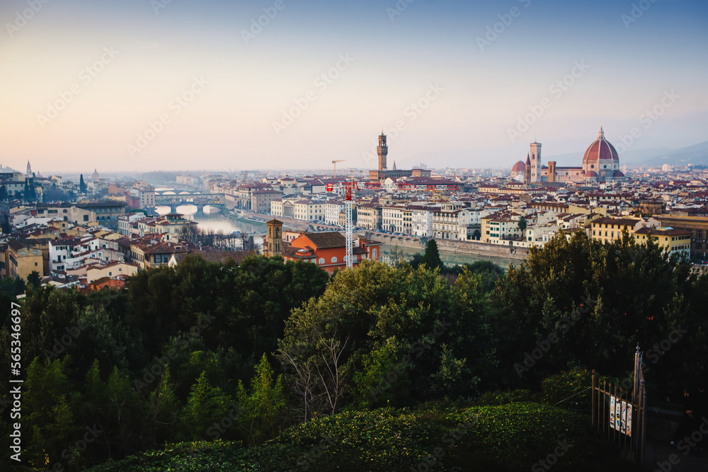 Panoramic landscape of Tuscany. Sunset. View of Florence. Silhouettes of cypresses, historical