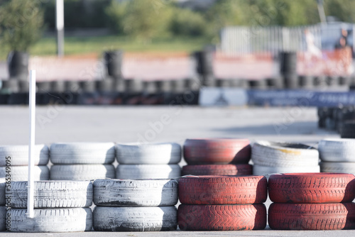 Tire barriers on asphalt along karting track