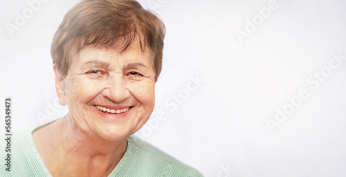 Portret of smiling, positive senior (elderly) women over the age of 50. Happy, healthy grandmother is on the white background, looking at camera.