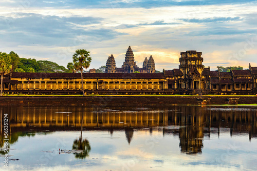 Angkor Wat temple reflecting in water before sunset