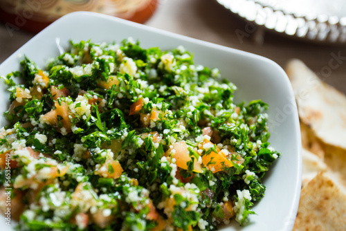 Tabuleh is a typical Shami or Levantine cuisine salad, consisting of chopped parsley, bulgur and other ingredients. It is one of the most traditional mezze appetizers, small dishes served together. photo